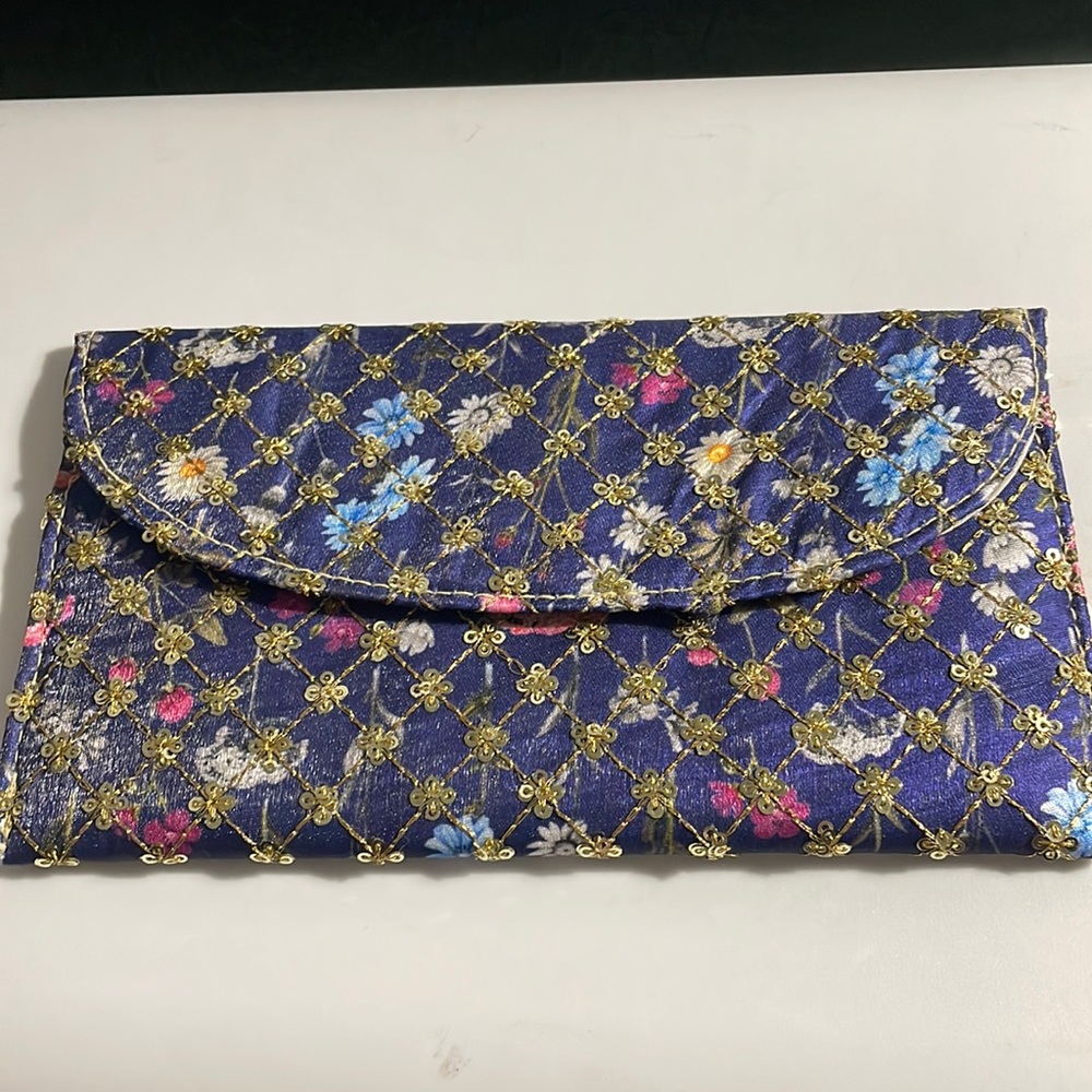Sequined blue and flora clutch